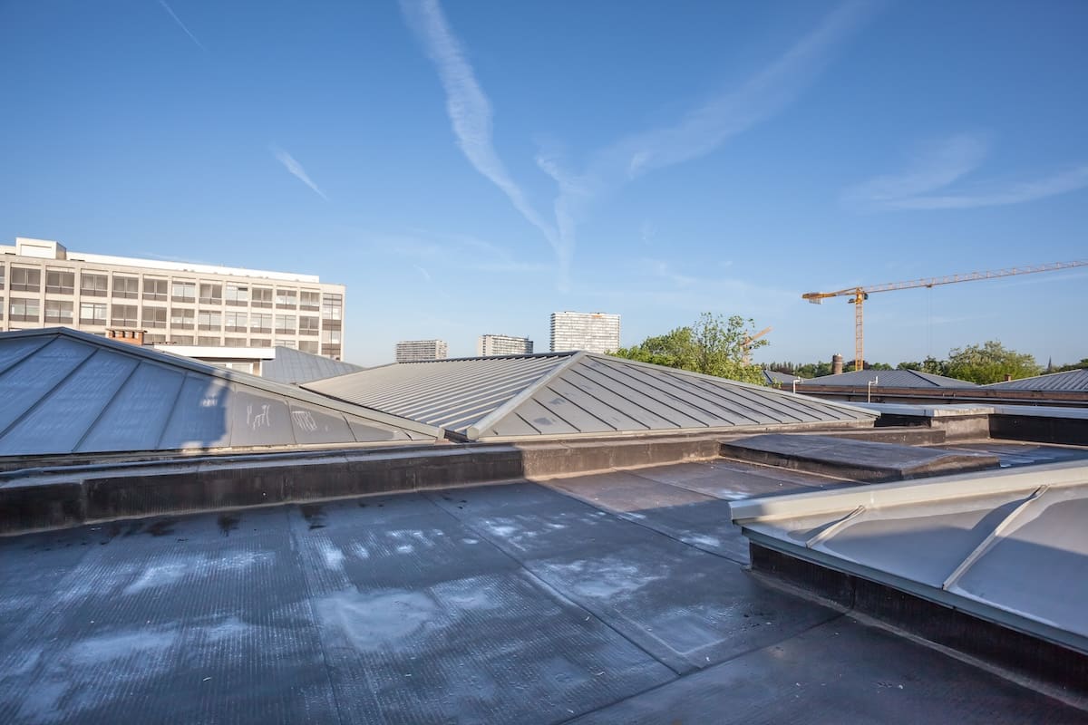 on a high building in the city there is cooling on a flat roof