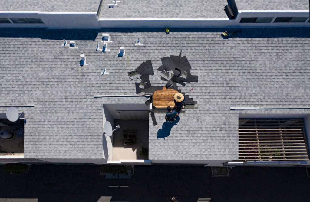 commercial roof leak repair Roof Repair Inspection In Progress Aerial Above Head Condo Building Gray Shingles 2 Roofers
