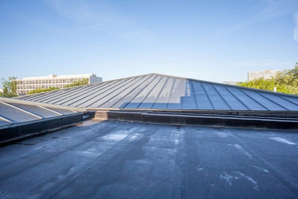 commercial roof warranty blue sky metallic grey roof and black cover