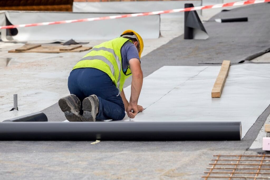 single ply membrane roof Waterproofing and insulation at construction site, waterproofing membrane preventing water penetration. Exterior vapor barrier for foundations and basements.