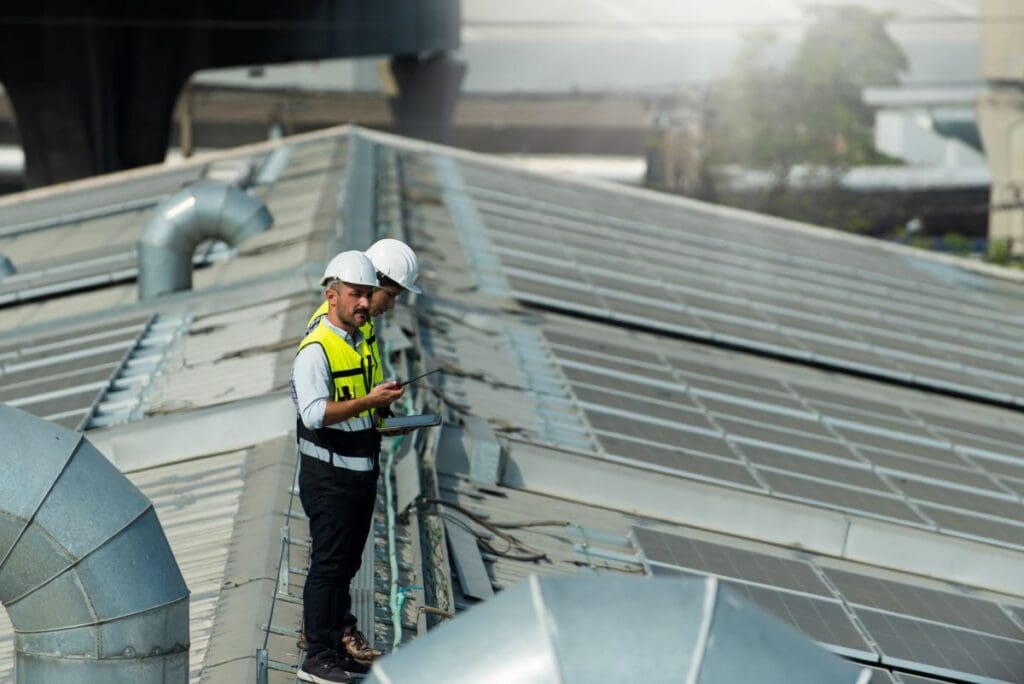 industrial roof replacement two workers on top inspecting