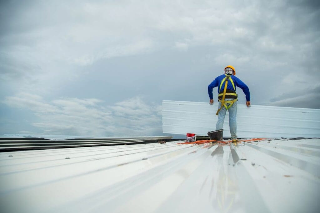 abc step safety award worker repairing corrugated metal roof