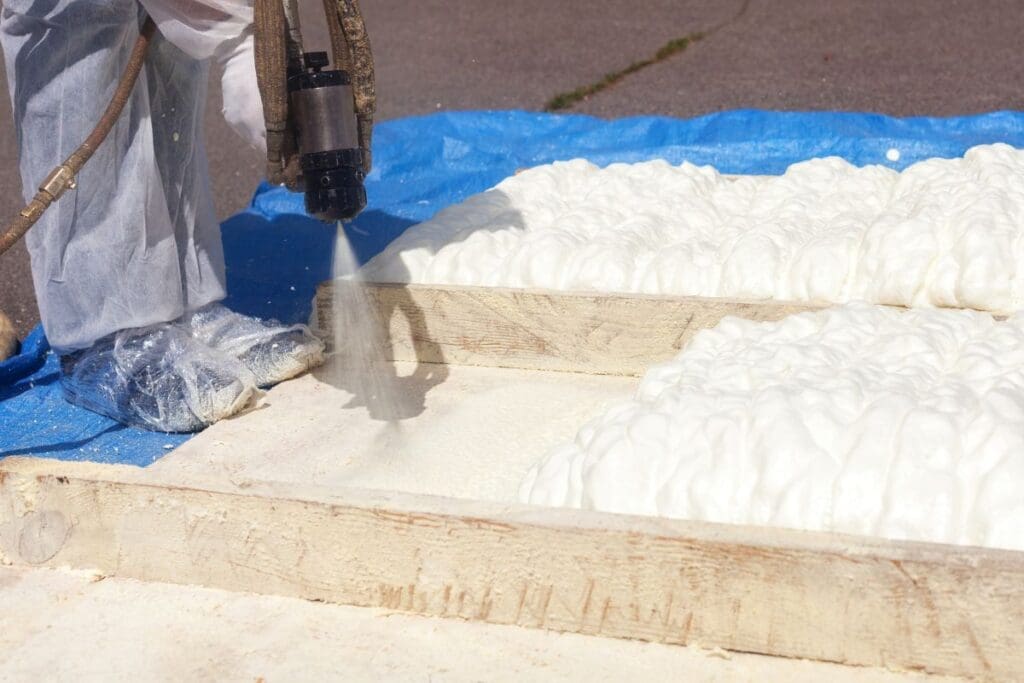 spray foam roof insulation worker applying