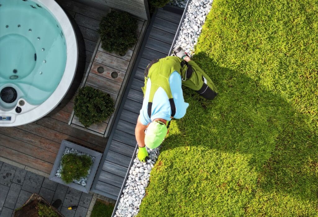 green roof maintenance worker installing small stones and grass