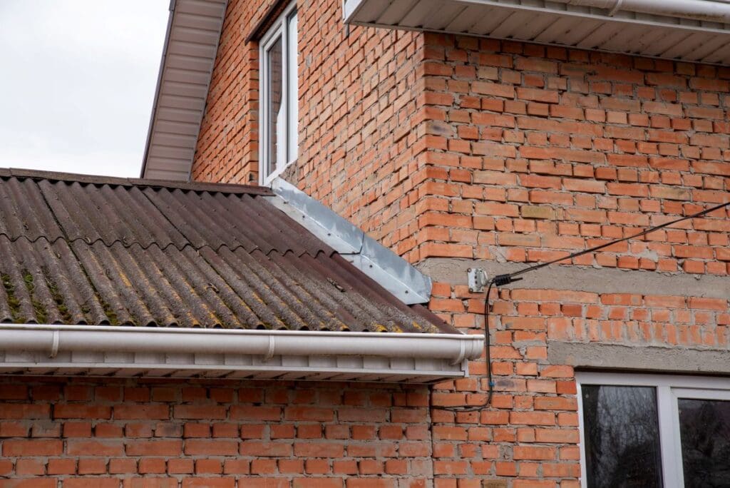 metal roof flashing types old brick wall
