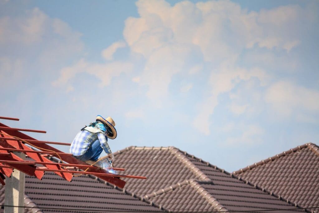 metal roof flashing worker installing metallic roof