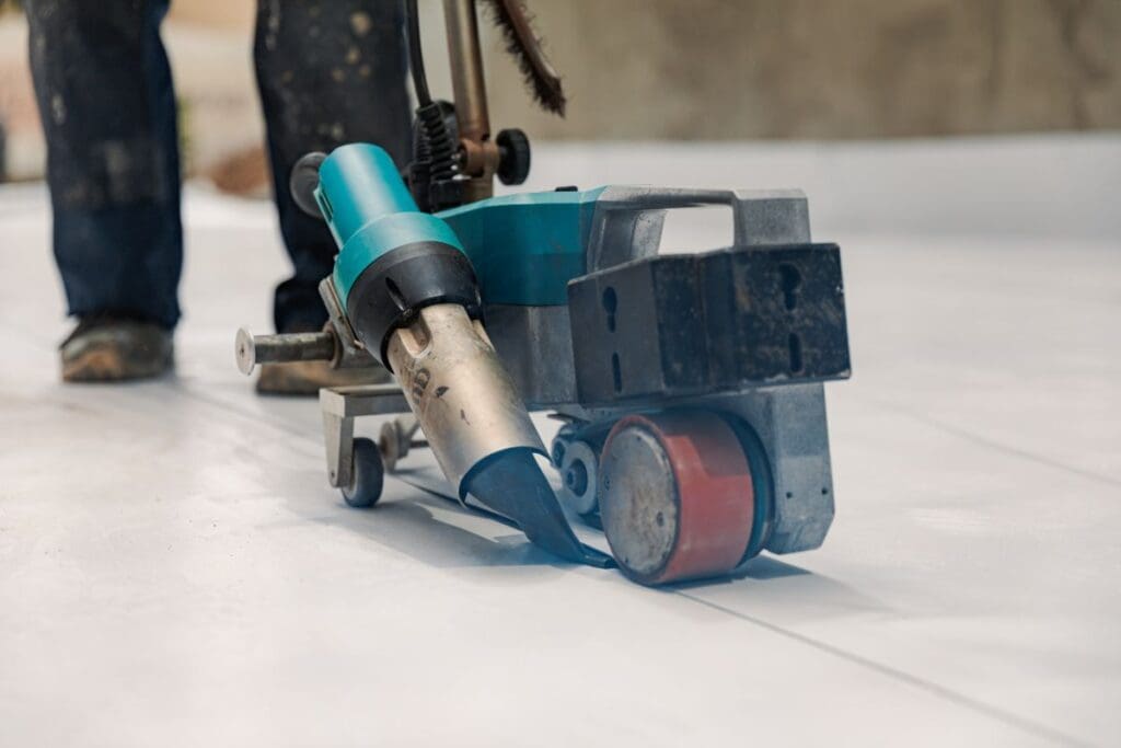 tpo roofing maintenance worker holding machine