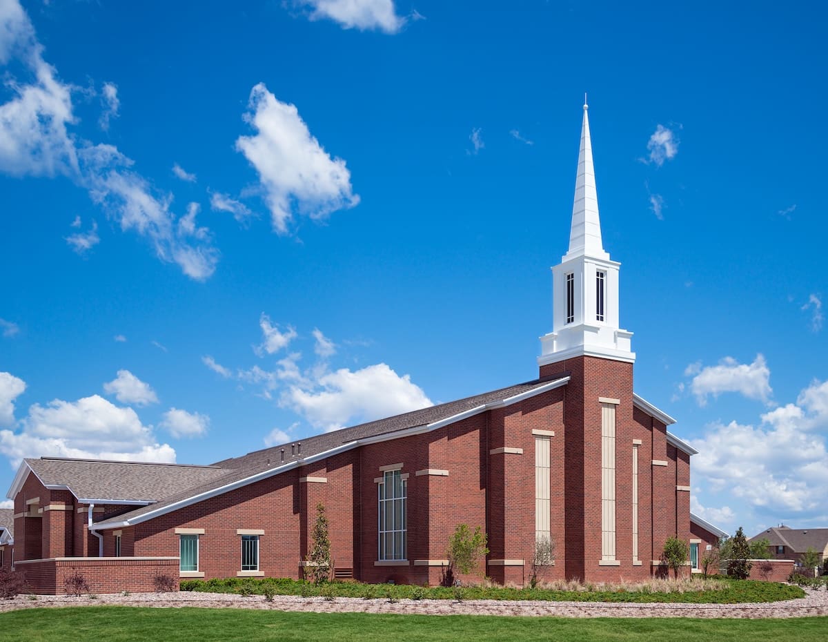 church against blue sky and white clouds