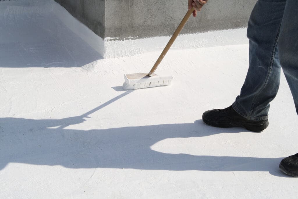 silicone roof coating guy standing on top of roof