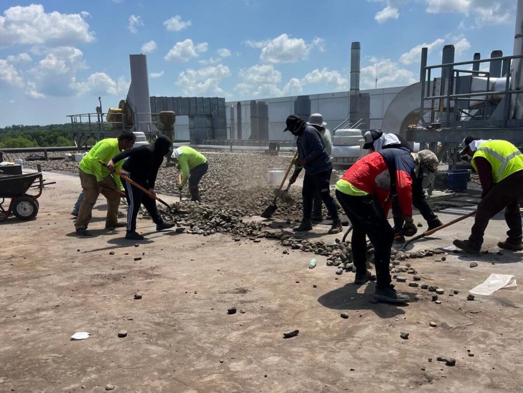 silicone roof coating workers removing old roof
