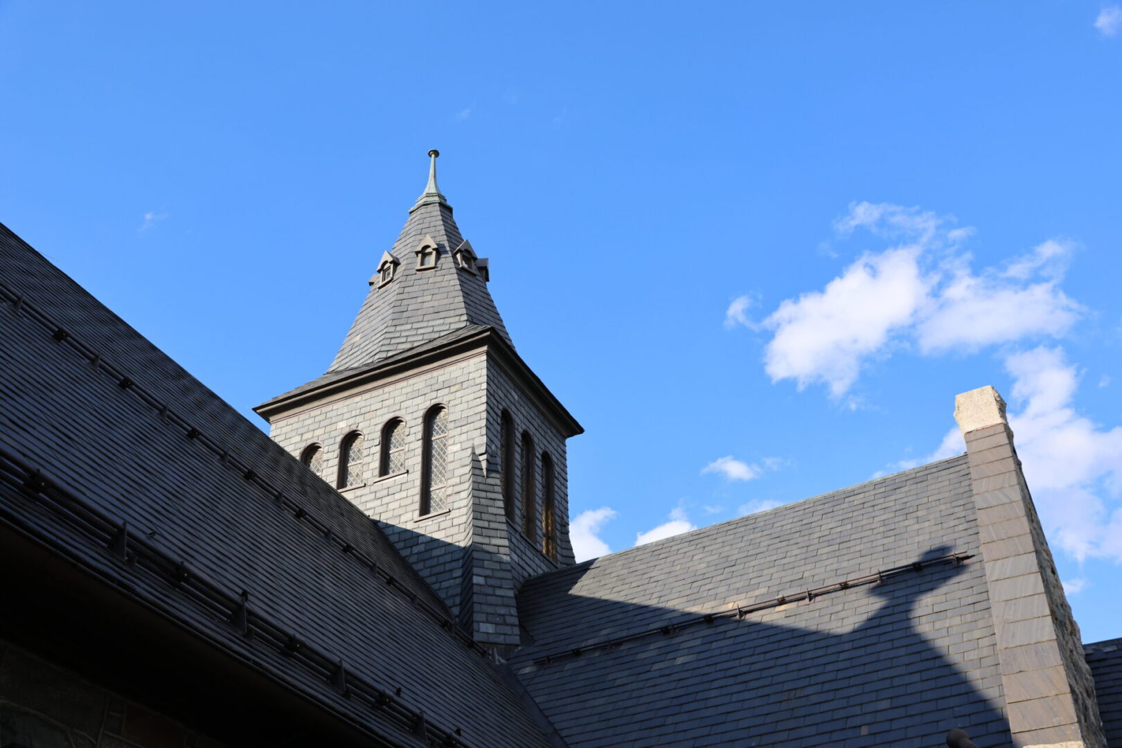 grey shingles roof blue sky