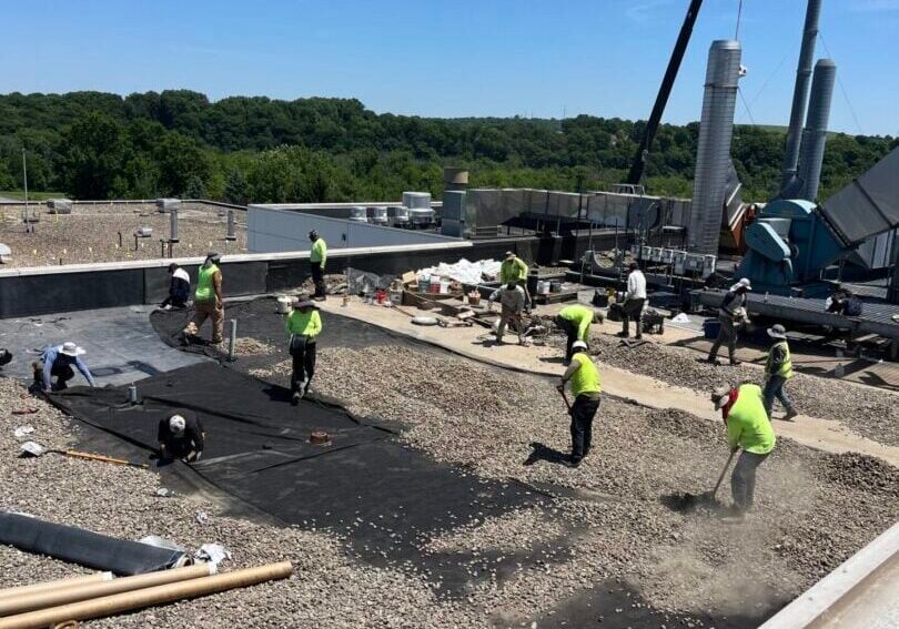 asphalt flat roof repair Weathertite workers repairing asphalt