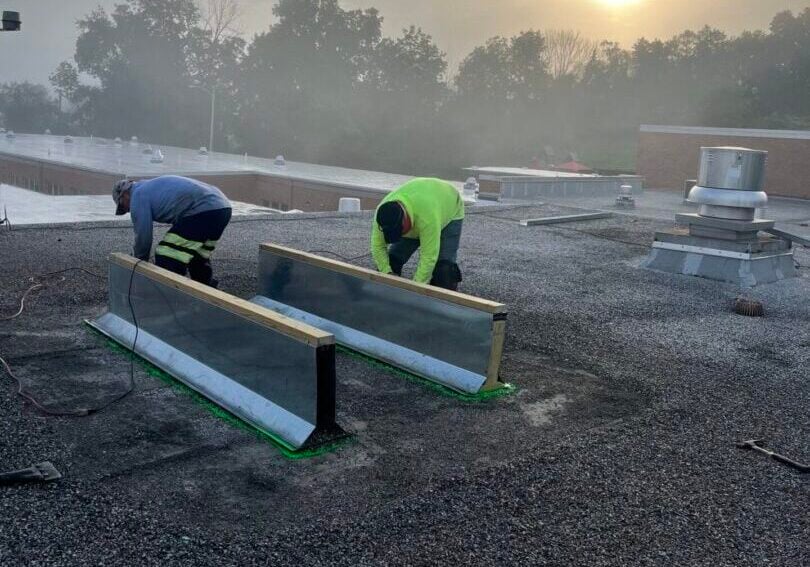 how to repair flat roof felt workers installing something