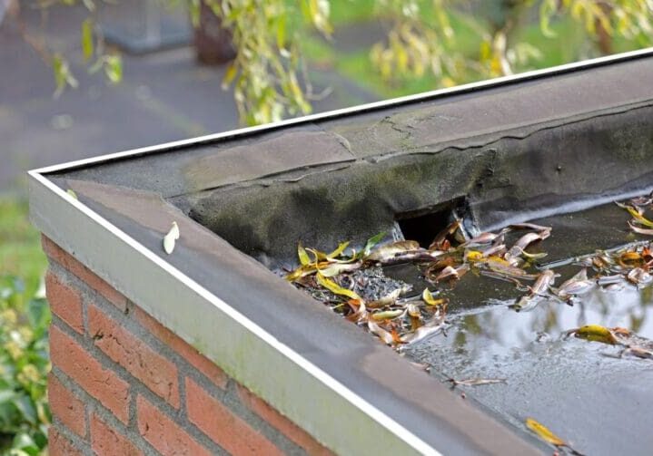 how do flat roofs drain debris on top of roof