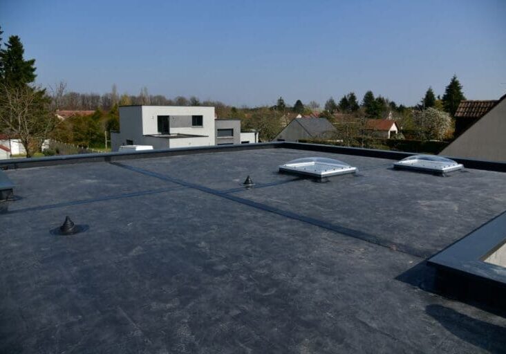 rubber roofing worker aerial view flat roof EPDM