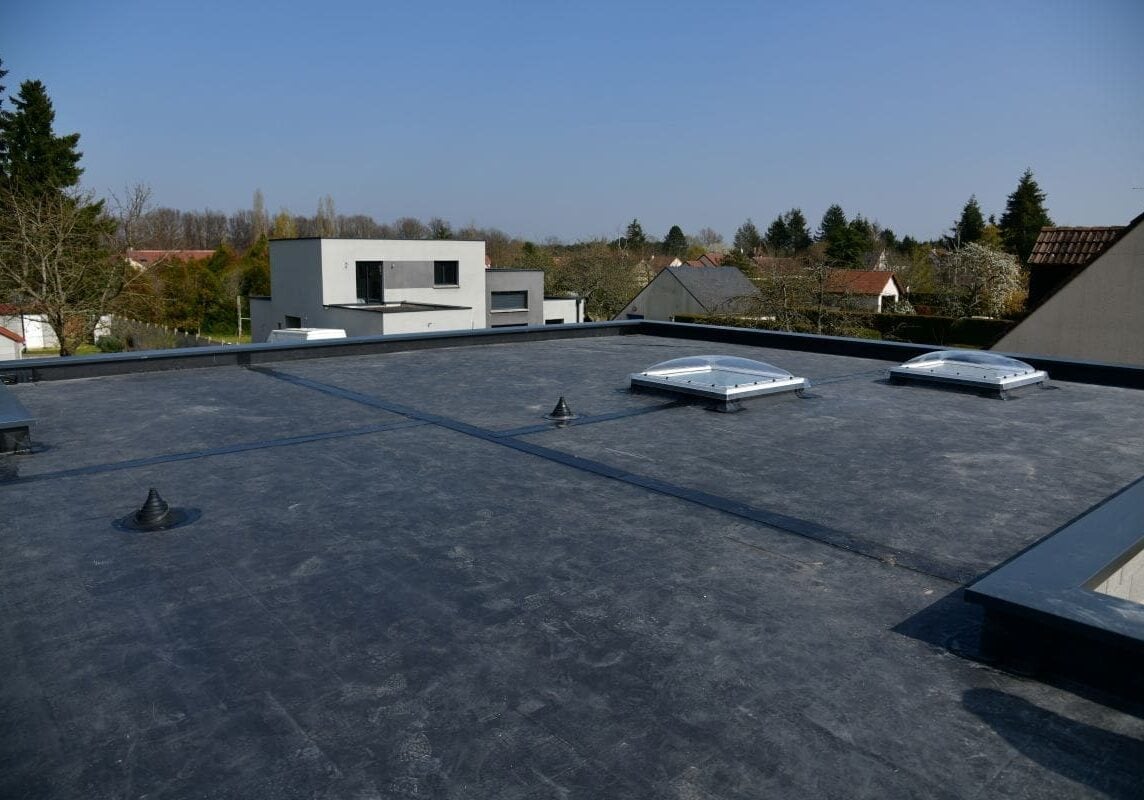 rubber roofing worker aerial view flat roof EPDM